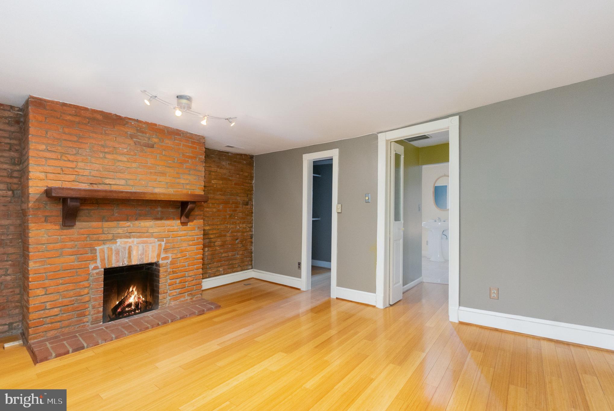 1118 Riverside Avenue Baltimore, MD 21230 - Photo 19 of 28 a view of empty room with wooden floor and fireplace