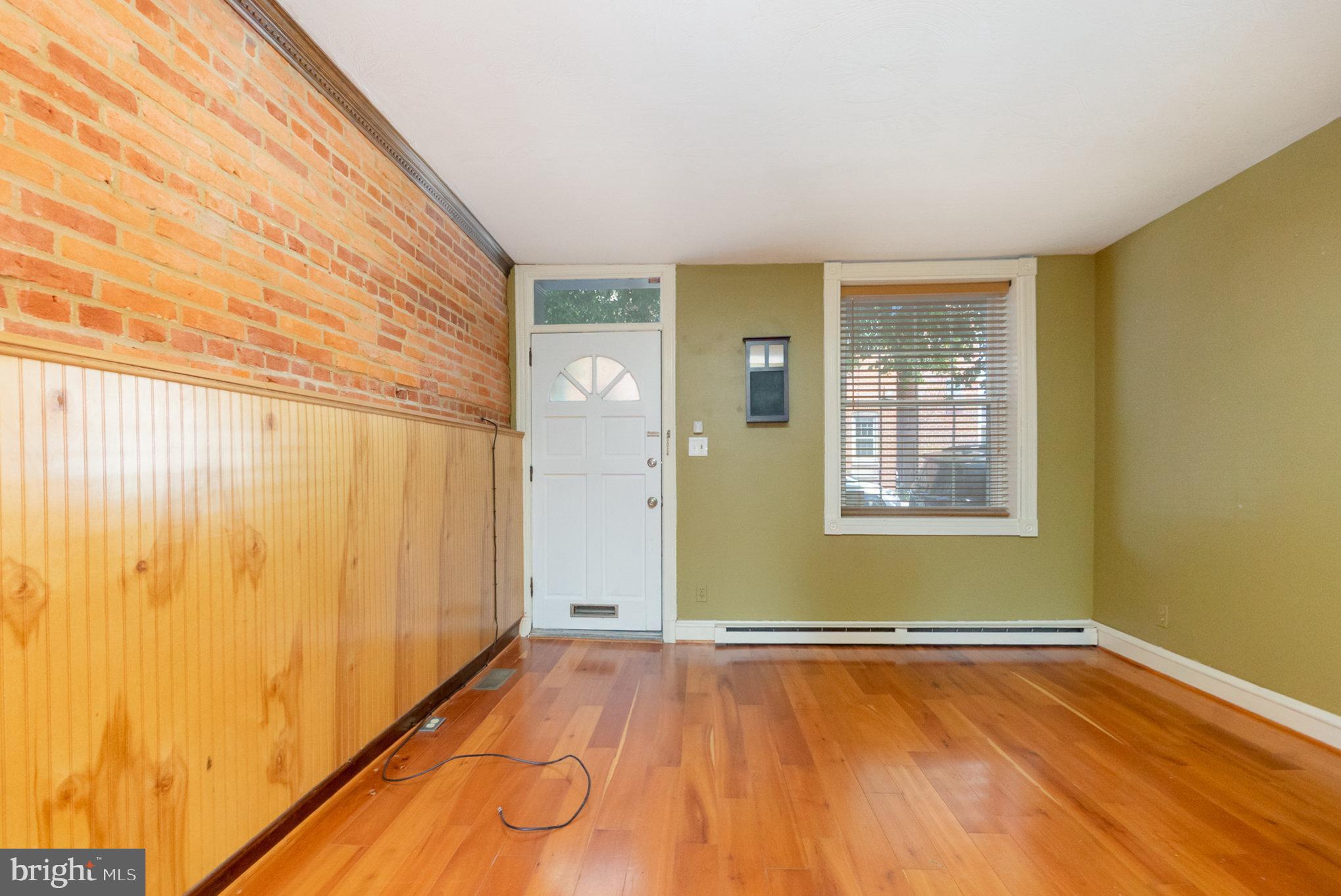 1118 Riverside Avenue Baltimore, MD 21230 - Photo 5 of 28 a view of an empty room with wooden floor and a window