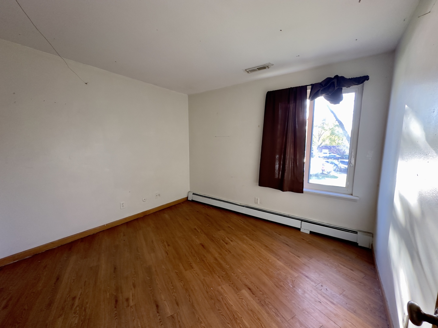 2100 Light Road, Unit 206 Oswego, IL 60543 - Photo 8 of 15 a view of an empty room with wooden floor and a window