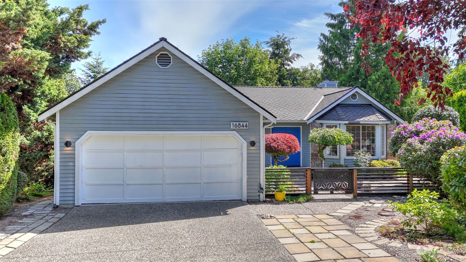 16844 119th Place Northeast Bothell, WA 98011 - Photo 1 of 26 a view of a house with wooden fence next to a yard