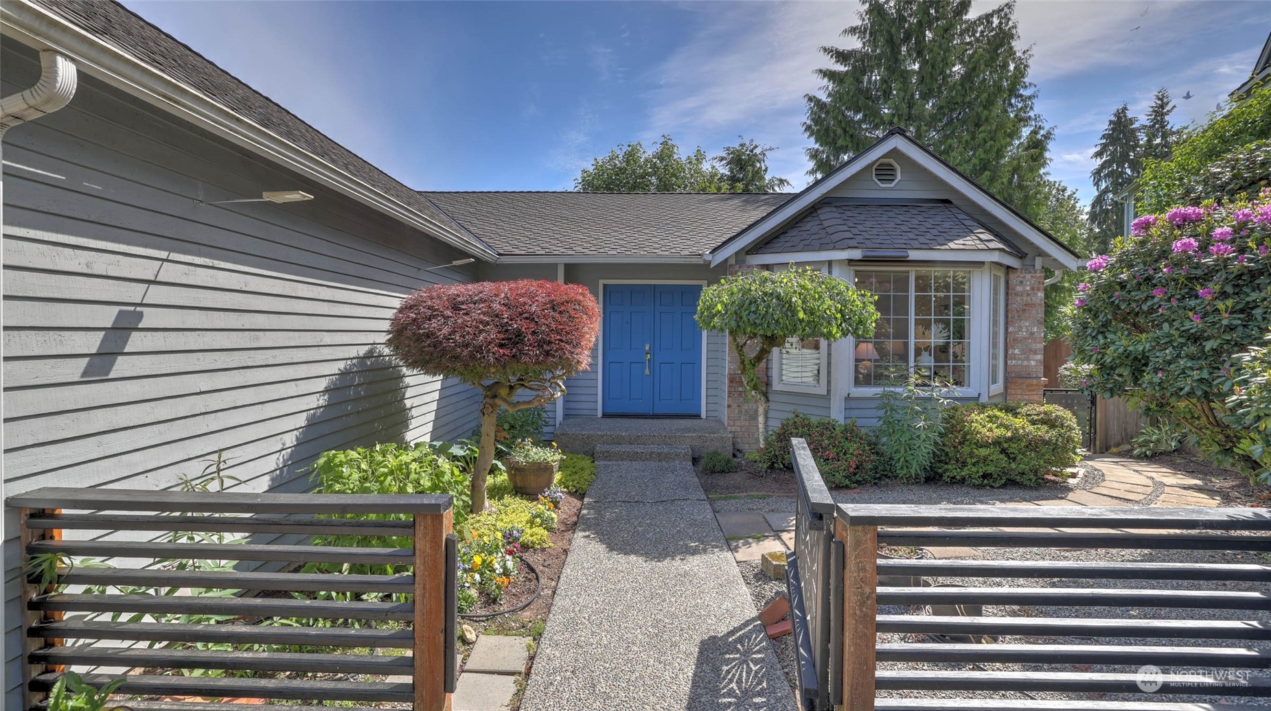 16844 119th Place Northeast Bothell, WA 98011 - Photo 2 of 26 a front view of a house with garden