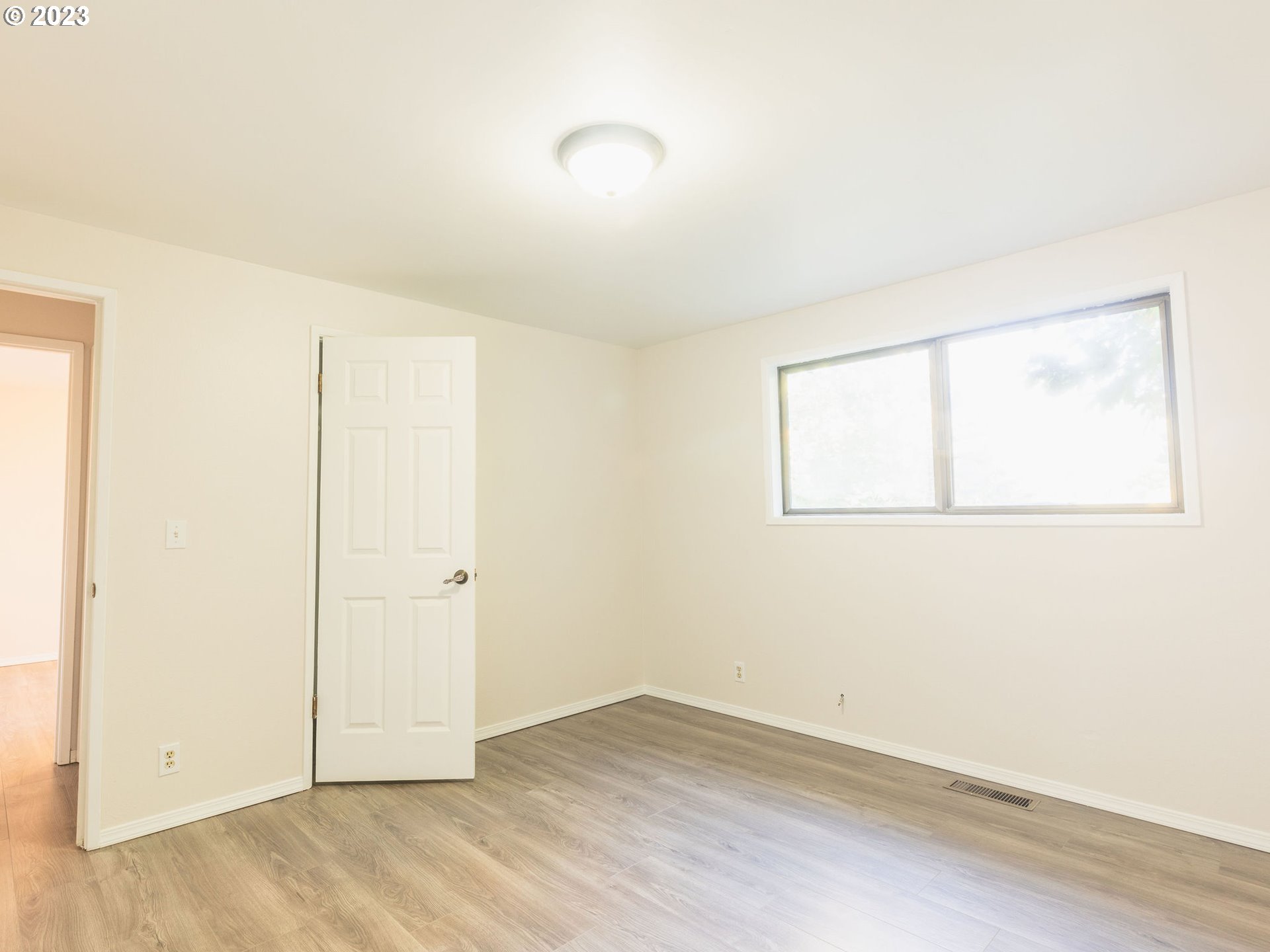 34609 Southeast Hurlburt Road Corbett, OR 97019 - Photo 27 of 48 an empty room with wooden floor and windows