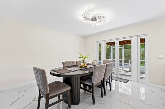 a view of a dining room with furniture and a potted plant