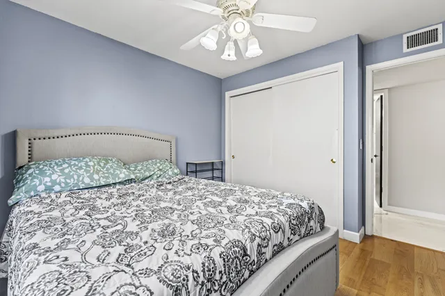 a bedroom with a large bed and a chandelier