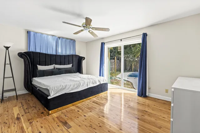a bedroom with a large bed and a large window