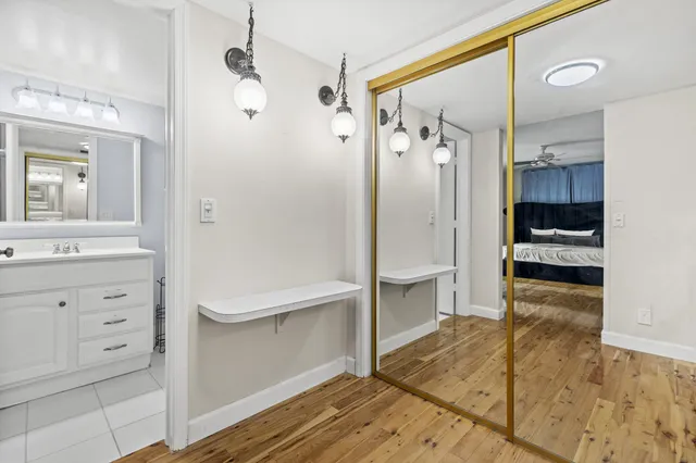 a bathroom with a tub shower sink and mirror