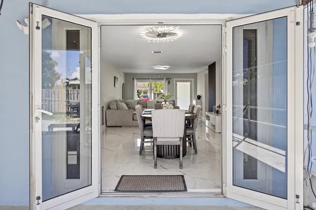 a living room with lots of furniture and a chandelier