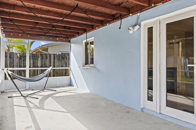 a view of a chairs and table in the back of the house