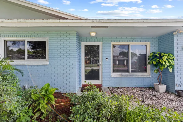 a front view of a house with a plant