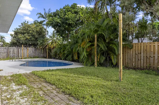 a view of a backyard with swimming pool