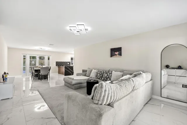 a living room with furniture flowerpot and window