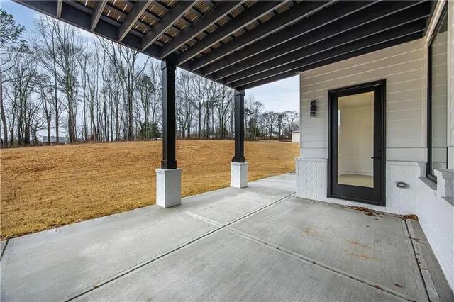a large kitchen with a large counter top stainless steel appliances and wooden floor
