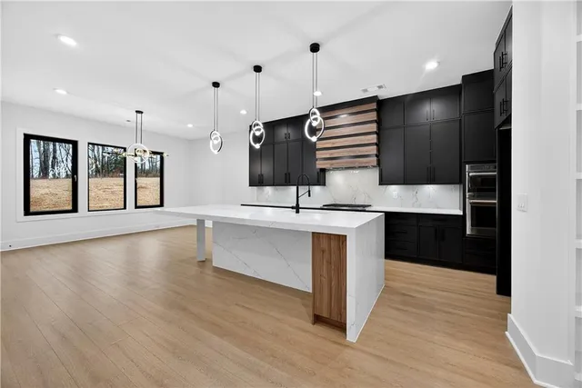 a view of a living room kitchen and a chandelier