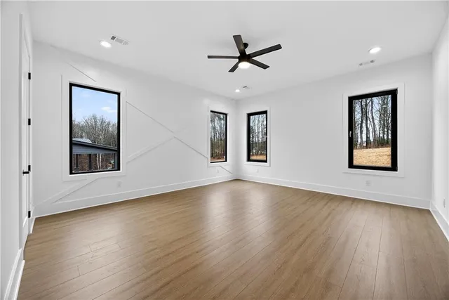 a view of a livingroom with a hardwood floor and a ceiling fan
