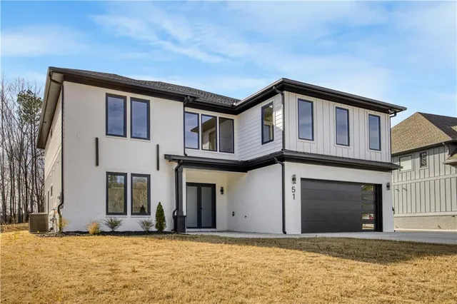 a house that has a large tree in front of it