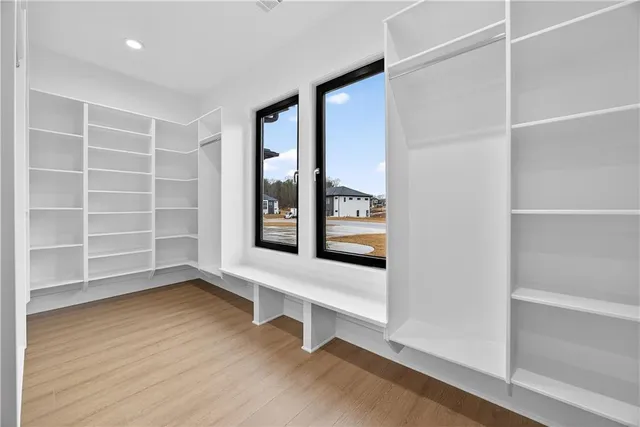 a kitchen with white cabinets and sink