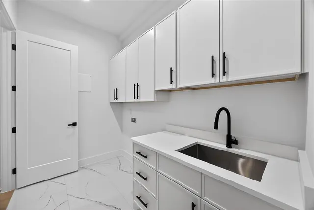 a view of hallway with window and wooden floor
