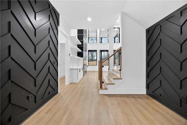 a view of entryway and hall with wooden floor