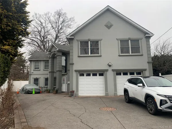 a front view of a house with parking space
