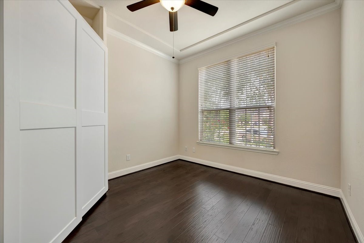 5410 Marble Acres Court Houston, TX 77059 - Photo 11 of 49 an empty room with wooden floor chandelier fan and windows