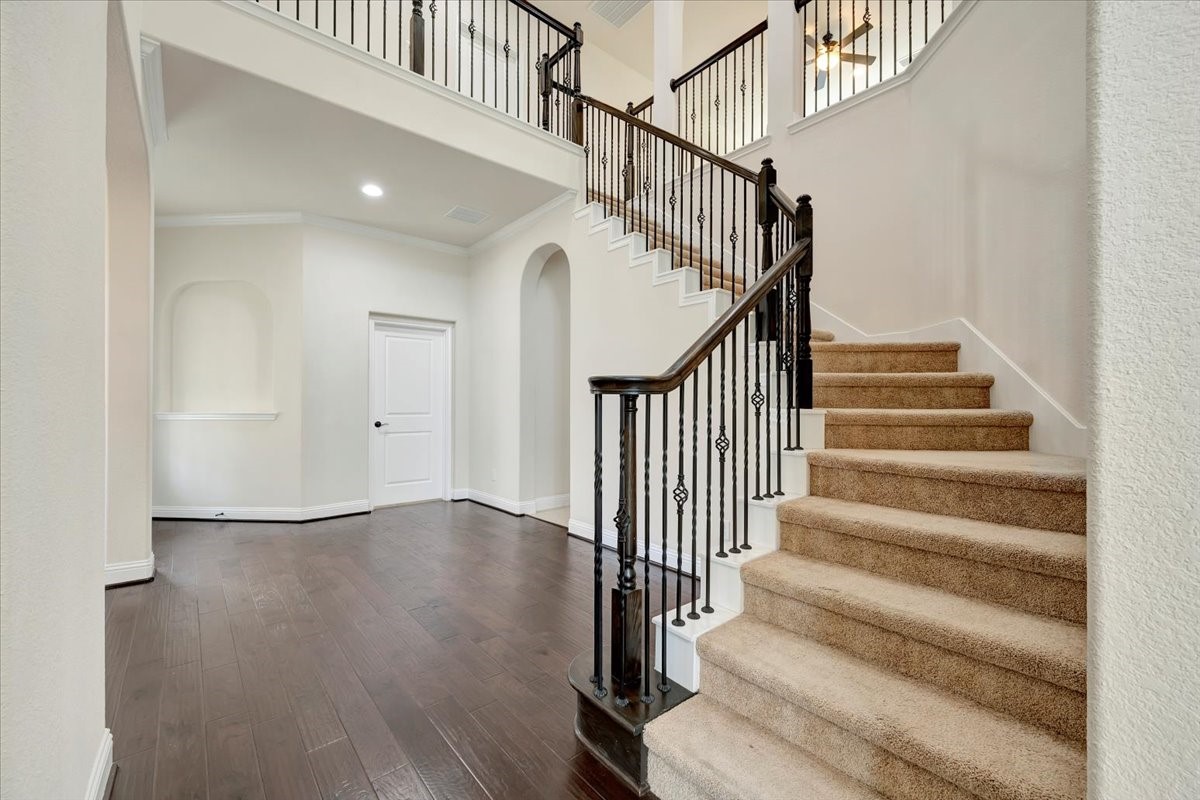5410 Marble Acres Court Houston, TX 77059 - Photo 13 of 49 a view of staircase with wooden floor and white walls