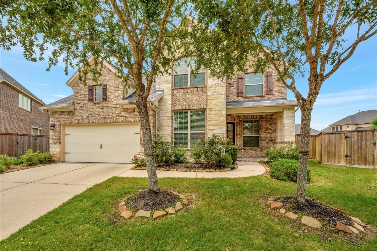 5410 Marble Acres Court Houston, TX 77059 - Photo 2 of 49 a front view of a house with a yard and large tree