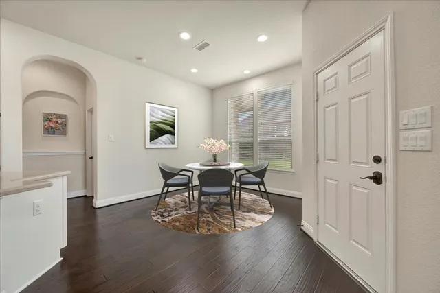 a dining room with furniture and wooden floor