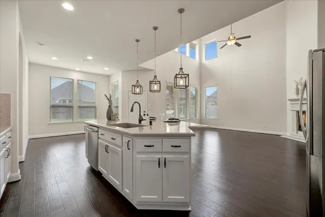 a kitchen with counter top space and wooden floor