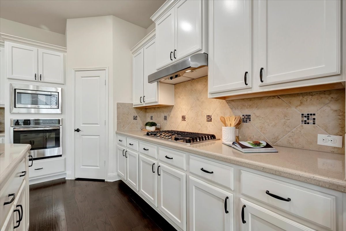 5410 Marble Acres Court Houston, TX 77059 - Photo 28 of 49 a kitchen with stainless steel appliances a white stove and cabinets