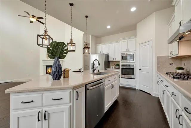 a kitchen with kitchen island white cabinets and white appliances