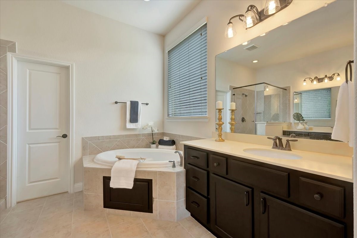 5410 Marble Acres Court Houston, TX 77059 - Photo 31 of 49 a bathroom with a double vanity sink a mirror and a bathtub