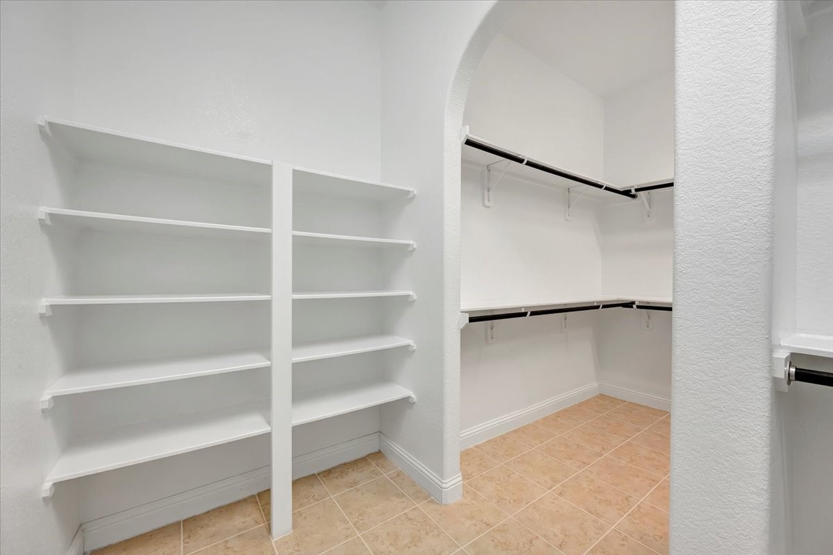 5410 Marble Acres Court Houston, TX 77059 - Photo 34 of 49 a view of walk in closet with empty racks
