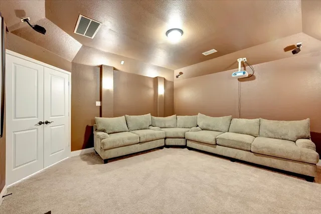 a living room with furniture and a ceiling fan
