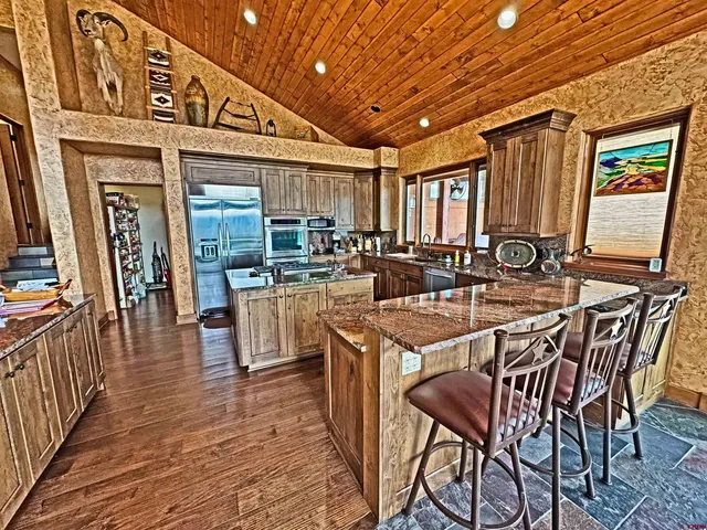 a kitchen with stainless steel appliances granite countertop a stove and refrigerator