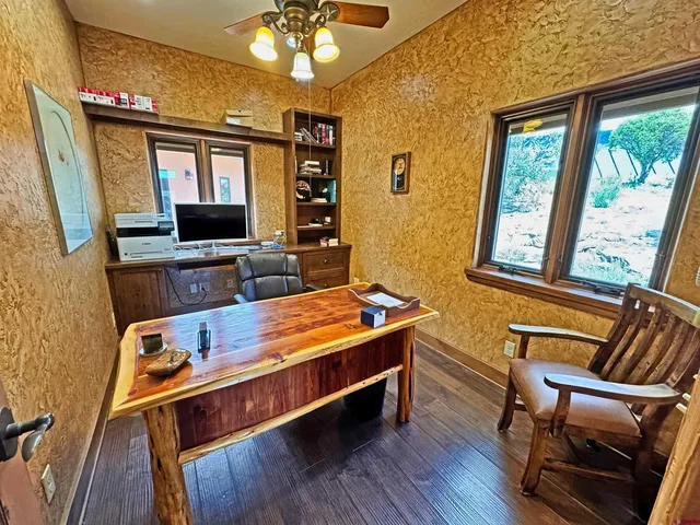 a room with furniture pool table flat screen tv and windows