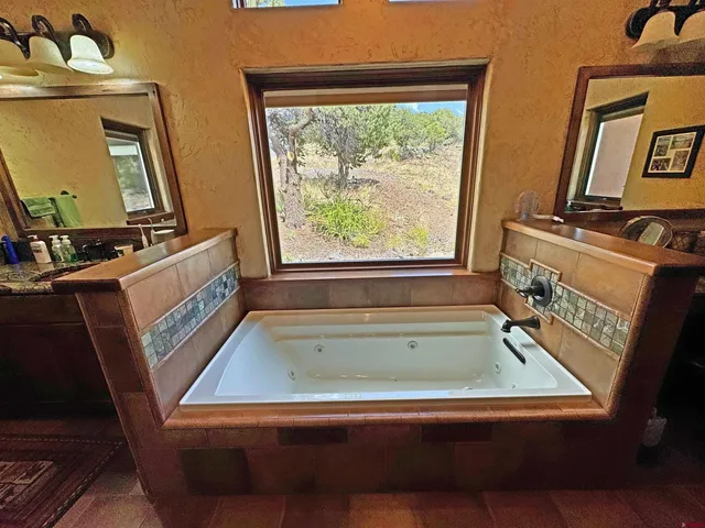 a bathroom with sink bathtub and mirror