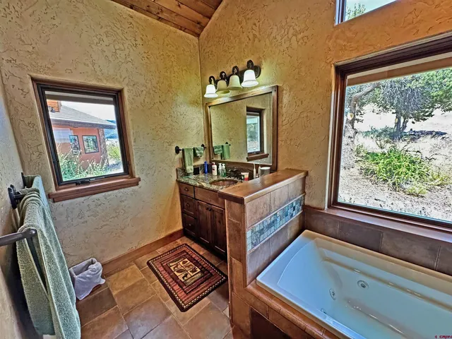 a bathroom with a shower and a sink a mirror