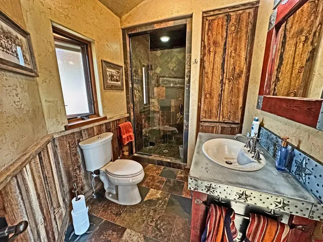 a spacious bedroom with a bed and a chandelier