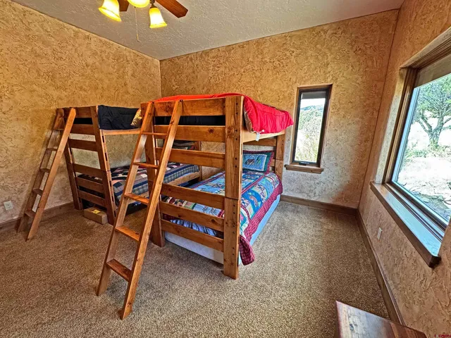 a bedroom with bed and a window