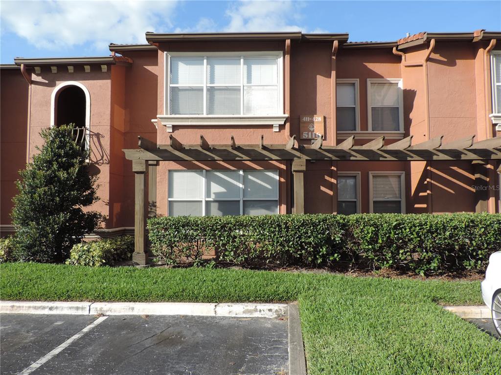 5116 Conroy Road, Unit 422 Orlando, FL 32811 - Photo 1 of 1 a front view of a house with garden