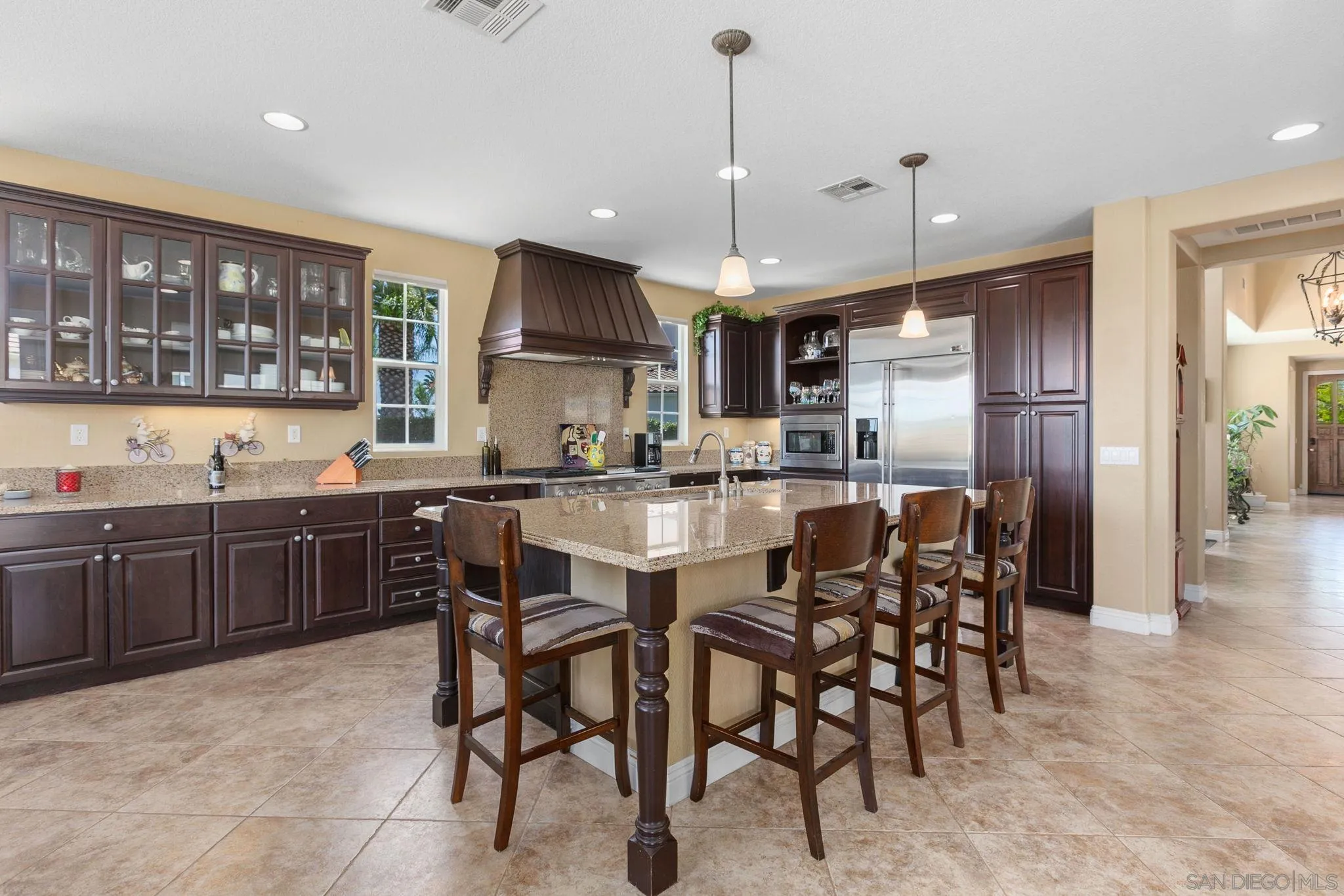 6340 Montecito Drive Carlsbad, CA 92009 - Photo 7 of 23 a kitchen with a table and chairs in it