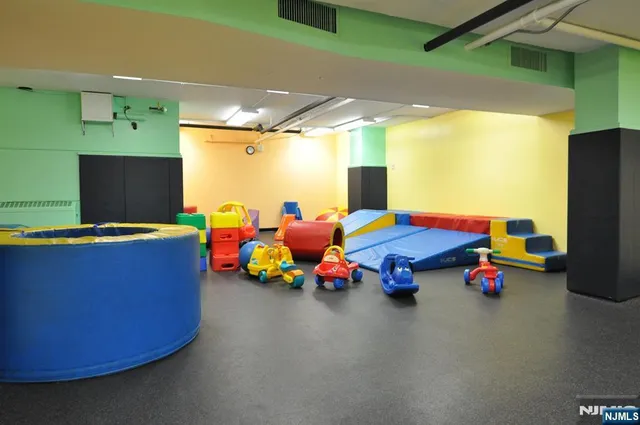 a play room with toys and tv