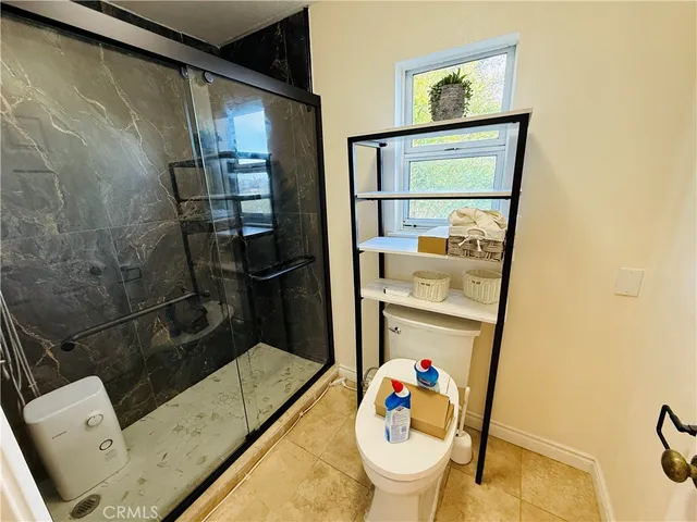 a bathroom with a sink mirror toilet and shower