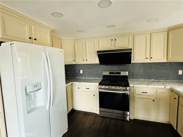 a kitchen with a stove a refrigerator and a sink