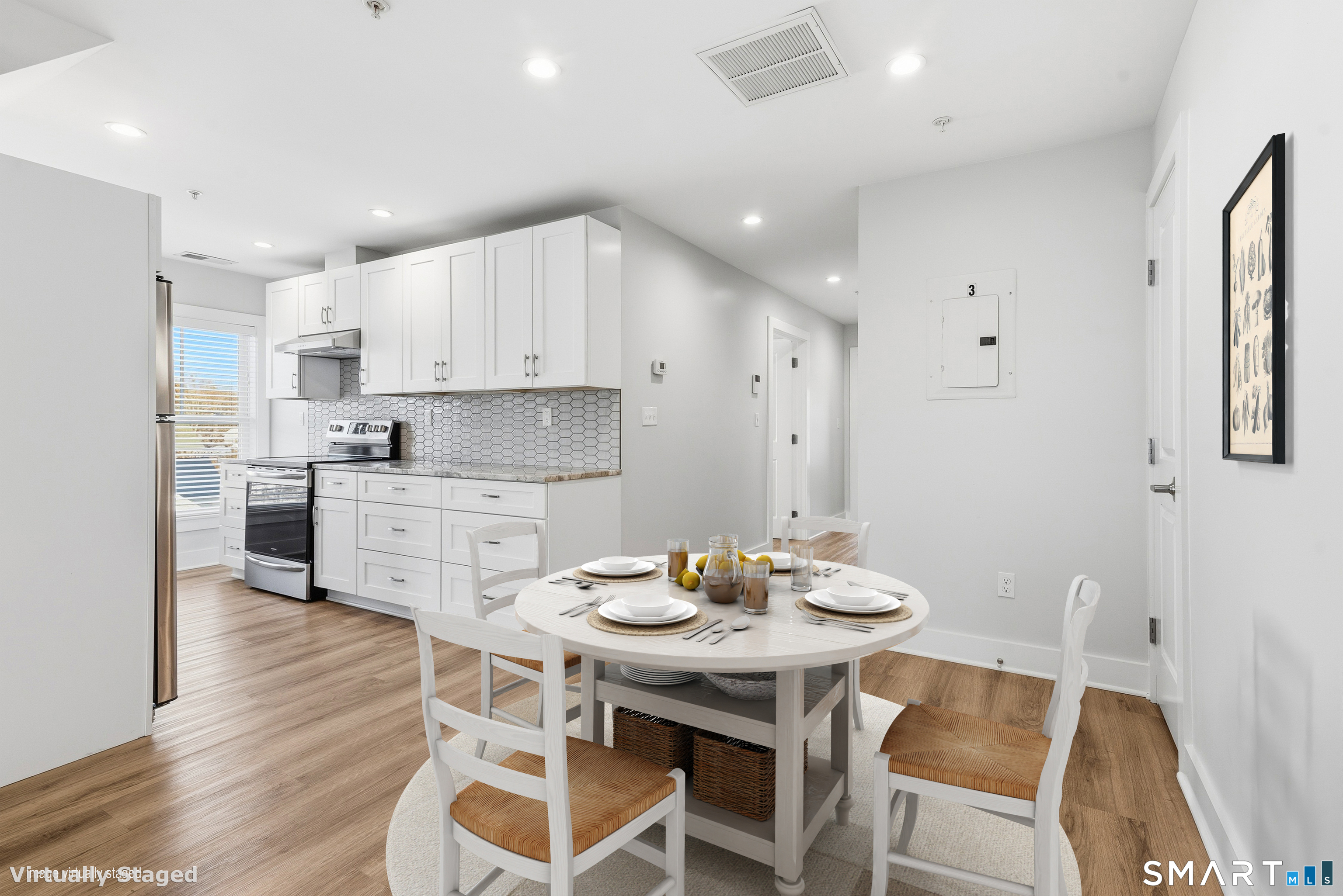 a kitchen with a dining table chairs and white cabinets