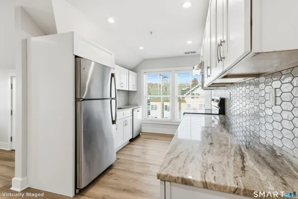 a kitchen with stainless steel appliances a refrigerator and a stove