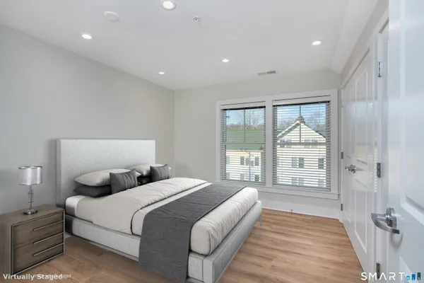 a bedroom with a large bed and a large window