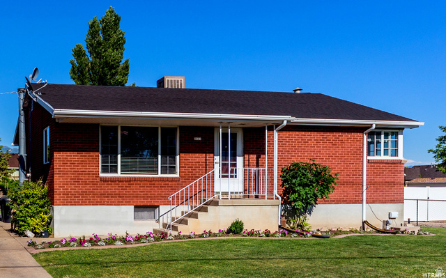 2423 South 2000th Street West Syracuse, UT 84075 - Photo 1 of 1 Ranch-style home with brick siding and a porch
