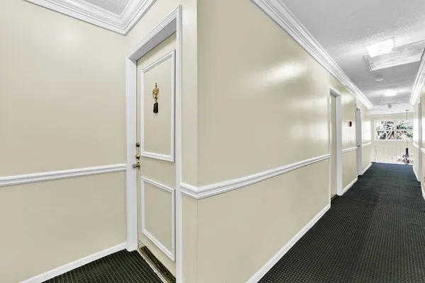 a view of an entryway with wooden floor