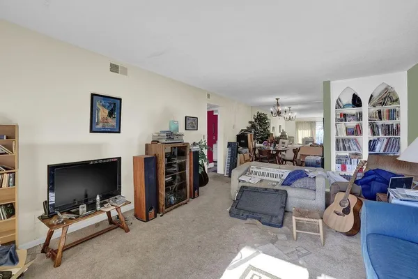 a view of a livingroom with furniture and a flat screen tv